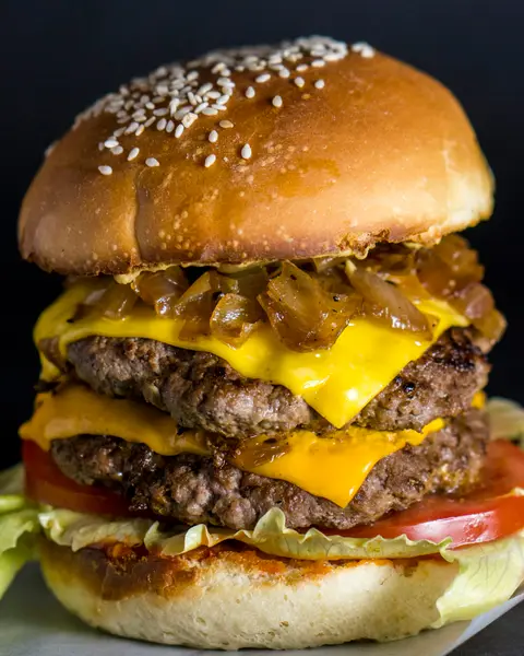 Double burger with a pile of grilled onions